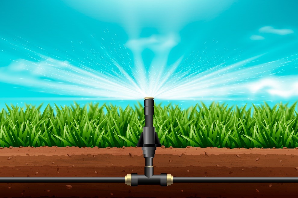 The visual depicts a sprinkler system in operation, watering a well-maintained lawn. Water droplets disperse in a radial pattern from the centrally located sprinkler. A clear blue sky sets the scene.